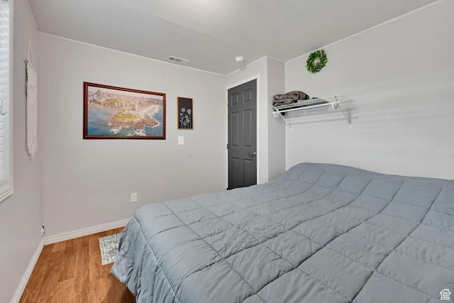 1087 N 1000 W, Clinton, UT 84015 - bedroom with baseboards, visible vents, and wood finished floors