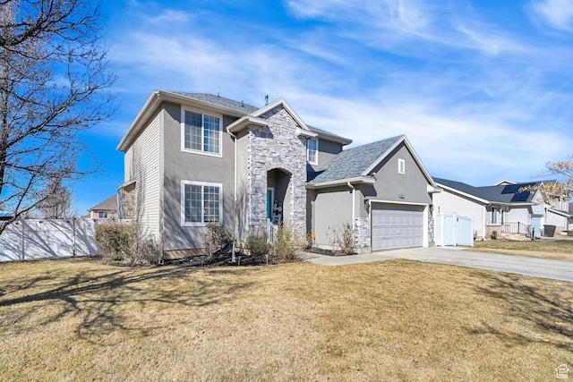 1087 N 1000 W, Clinton, UT 84015 - traditional home featuring concrete driveway, stone siding, an attached garage, fence, and a front lawn