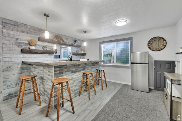 1087 N 1000 W, Clinton, UT 84015 - bar with indoor bar, freestanding refrigerator, wood tiled floor, a textured ceiling, and baseboards