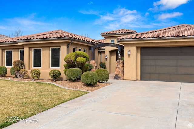 2275 E Rustic Dr, St George, UT 84790 - mediterranean / spanish-style house with a garage, a tile roof, driveway, stucco siding, and a front yard