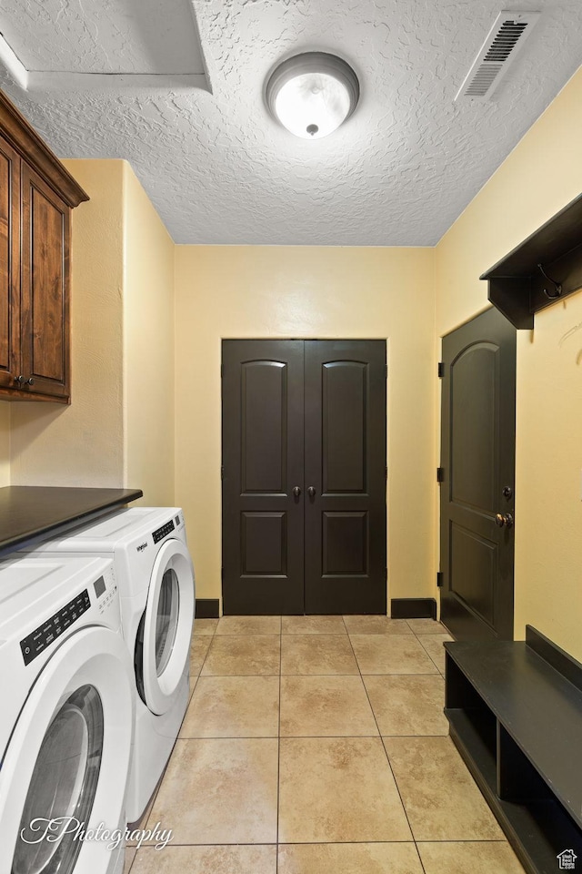 2275 E Rustic Dr, St George, UT 84790 - laundry area with cabinet space, light tile patterned floors, visible vents, washing machine and clothes dryer, and a textured ceiling