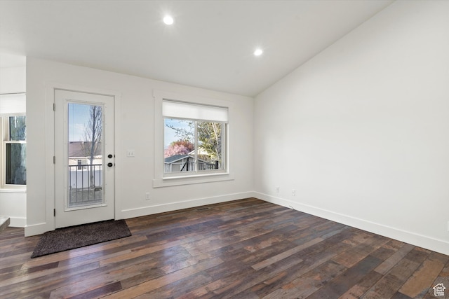 entryway featuring recessed lighting, dark wood finished floors, lofted ceiling, and baseboards