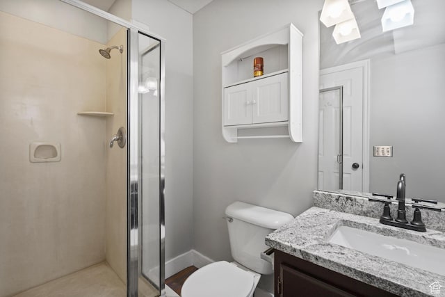 full bath featuring toilet, vanity, and a stall shower