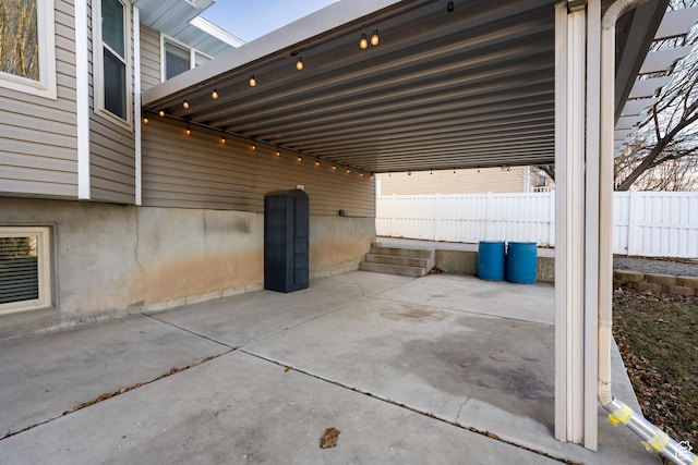 view of patio featuring fence and an attached carport