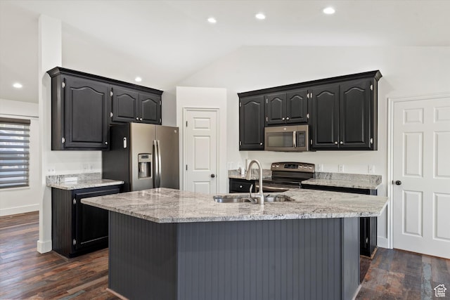 kitchen with vaulted ceiling, appliances with stainless steel finishes, a sink, and recessed lighting