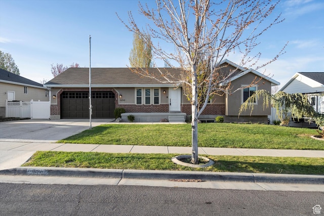 ranch-style house featuring fence, an attached garage, driveway, brick siding, and a front yard