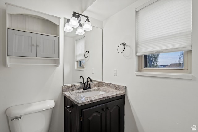 half bathroom with toilet and vanity