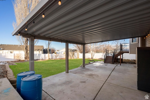 view of patio with a residential view, a fenced backyard, and stairway