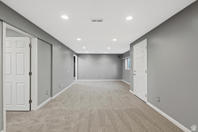 unfurnished room with light colored carpet, baseboards, visible vents, and recessed lighting