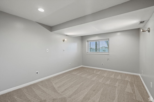 unfurnished room featuring baseboards, visible vents, and light colored carpet