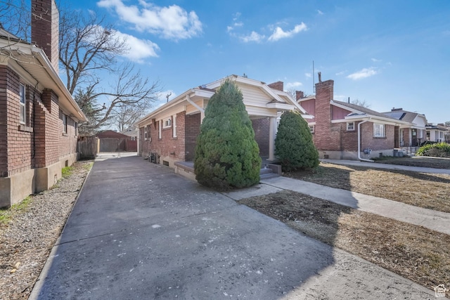view of home's exterior featuring a residential view and brick siding