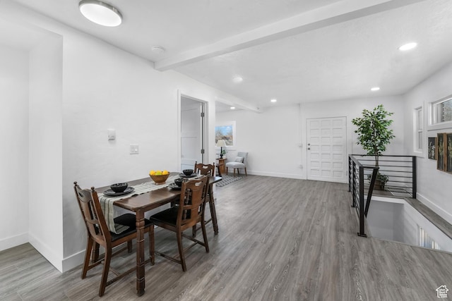dining space with recessed lighting, beam ceiling, baseboards, and wood finished floors