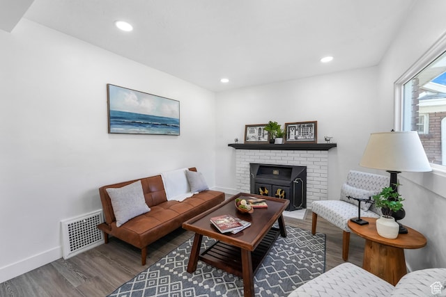 living area with recessed lighting, wood finished floors, visible vents, and baseboards