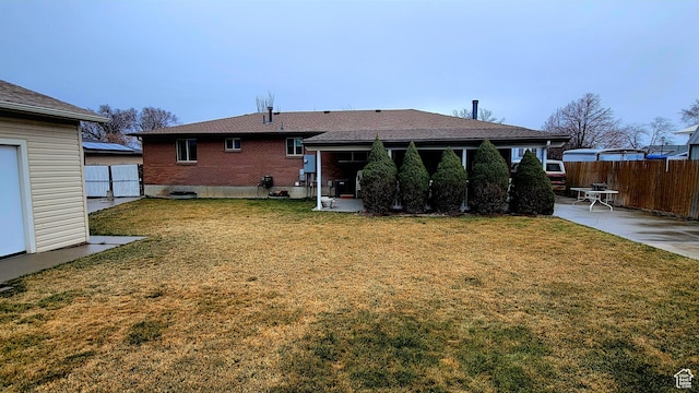4142 S 3425 W, West Valley City, UT 84119 - rear view of property featuring a patio area and brick siding