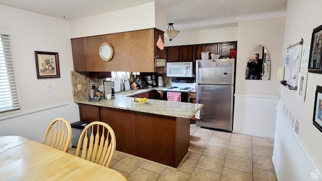 4142 S 3425 W, West Valley City, UT 84119 - kitchen with white appliances, a peninsula, a sink, light stone counters, and dark brown cabinets