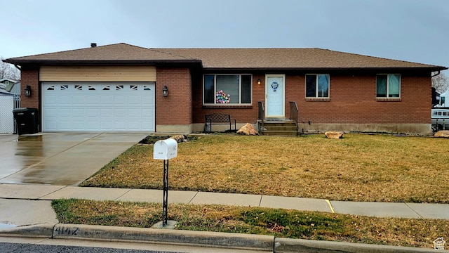 4142 S 3425 W, West Valley City, UT 84119 - ranch-style house with brick siding, an attached garage, concrete driveway, and a front lawn