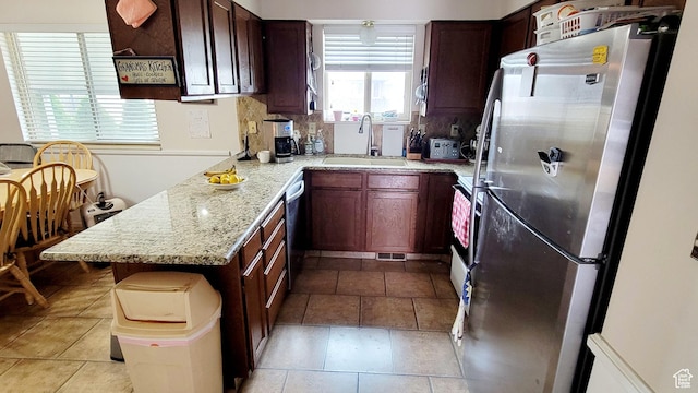 4142 S 3425 W, West Valley City, UT 84119 - kitchen featuring freestanding refrigerator, a sink, dishwasher, light stone countertops, and a peninsula