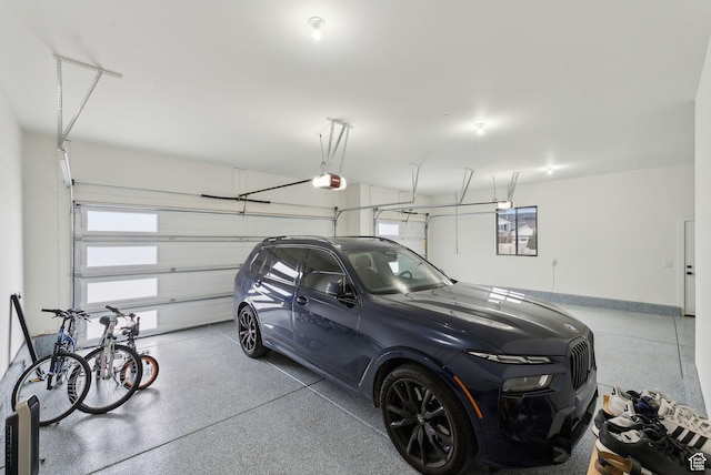 garage with baseboards and a garage door opener