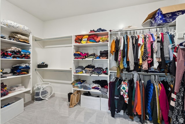 walk in closet with carpet