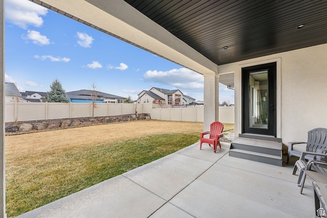 view of patio / terrace with entry steps, a fenced backyard, and a residential view