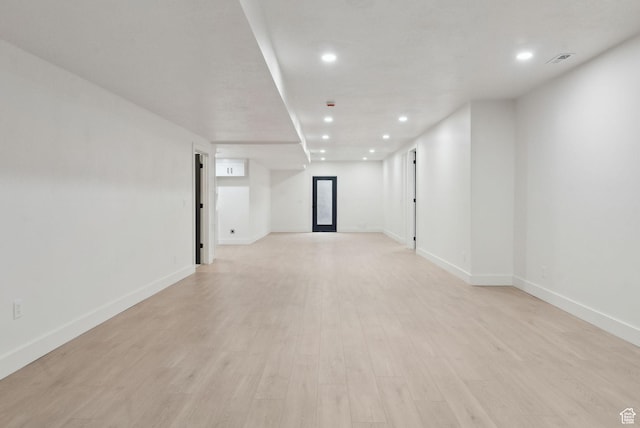 unfurnished room with recessed lighting, visible vents, and light wood finished floors
