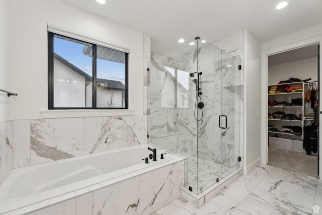 full bathroom featuring marble finish floor, a spacious closet, a marble finish shower, and recessed lighting