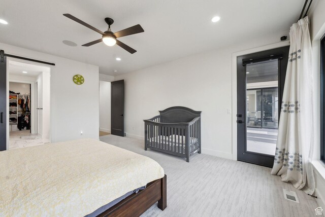 bedroom featuring a barn door, recessed lighting, carpet floors, a ceiling fan, and visible vents