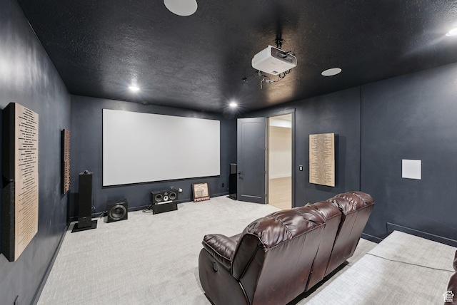 cinema room featuring a textured ceiling, carpet flooring, and baseboards