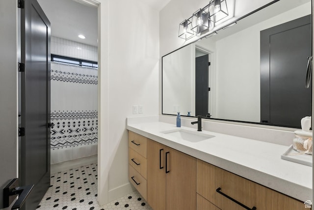 full bath with a shower with shower curtain, tile patterned flooring, and vanity