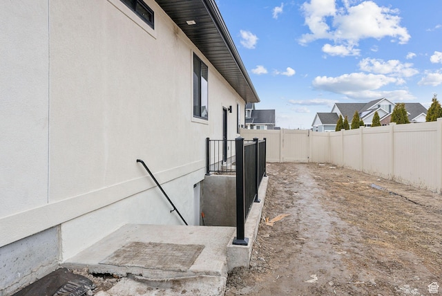 view of side of property with fence and a residential view