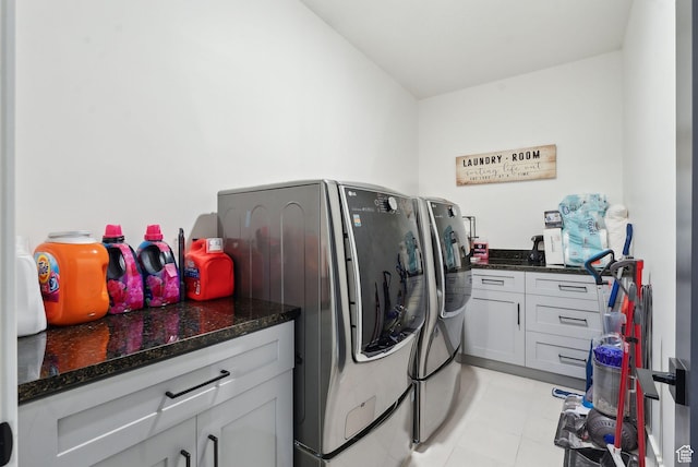 clothes washing area with independent washer and dryer and cabinet space