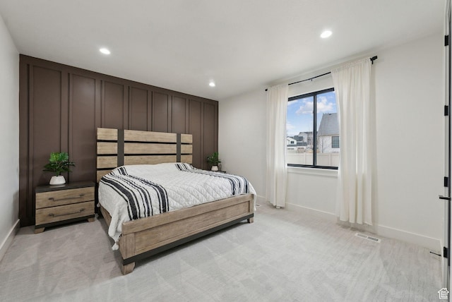 bedroom featuring recessed lighting, light colored carpet, visible vents, and baseboards