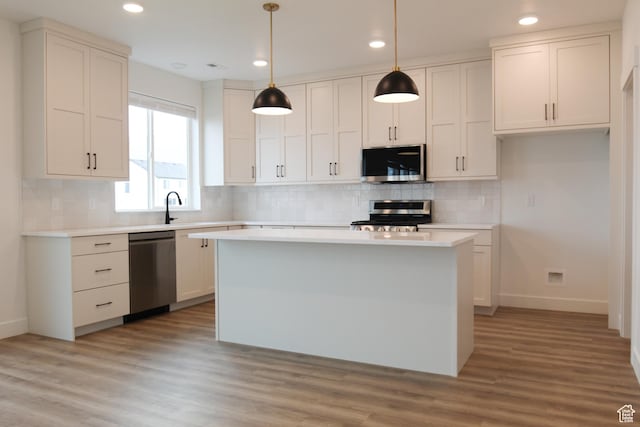 729 E 1250 S, Hyrum, UT 84319 - kitchen with stainless steel appliances, baseboards, recessed lighting, light countertops, and a center island