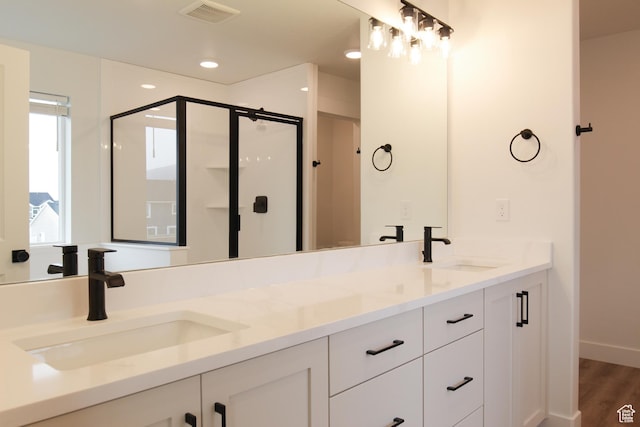 729 E 1250 S, Hyrum, UT 84319 - bathroom featuring a shower stall, double vanity, and wood finished floors
