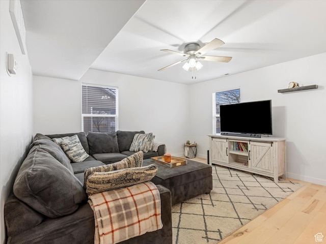 1673 N Aaron Dr E, Tooele, UT 84074 - living area with light wood-type flooring, a ceiling fan, and baseboards