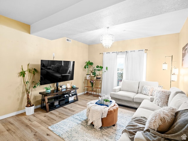 3478 S Cozy River Pl W Unit 203, West Valley City, UT 84119 - living room with an inviting chandelier, visible vents, baseboards, and wood finished floors