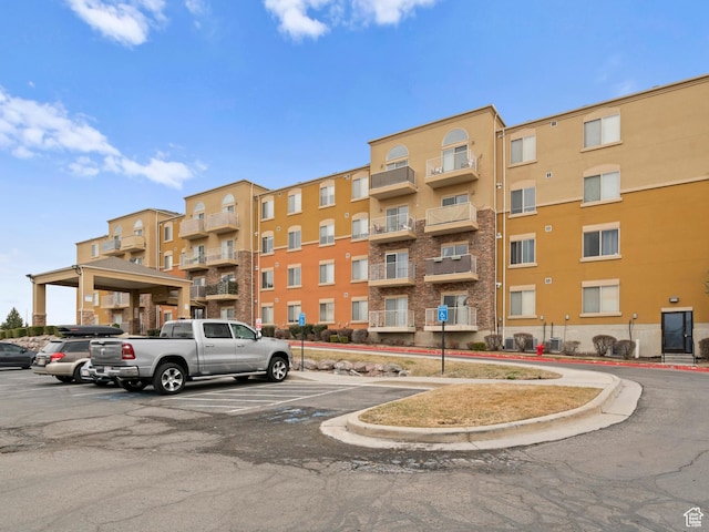 3478 S Cozy River Pl W Unit 203, West Valley City, UT 84119 - view of building exterior featuring uncovered parking