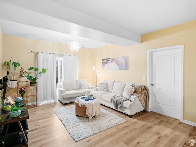 living room featuring a notable chandelier and light wood finished floors