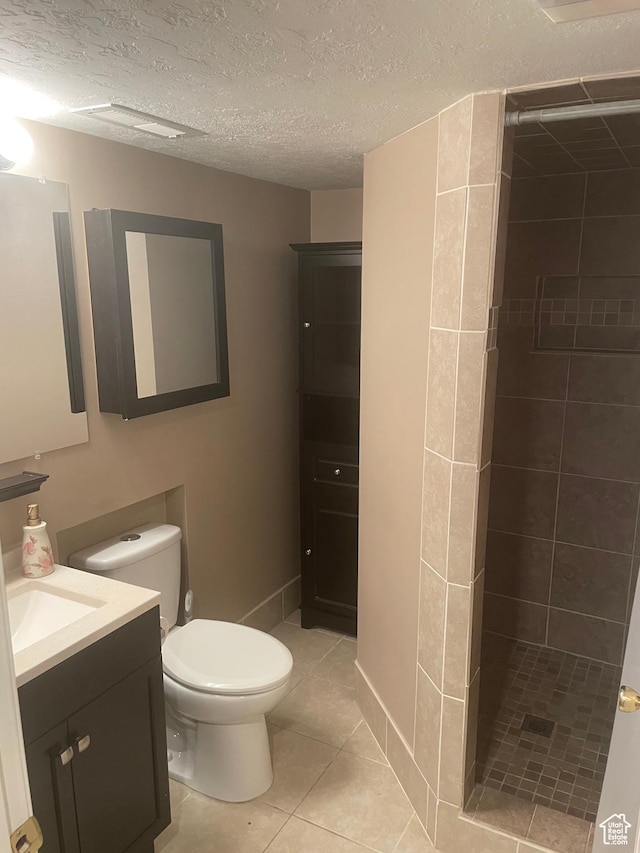 564 W 475 N, Clearfield, UT 84015 - bathroom with tile patterned flooring, tiled shower, vanity, toilet, and a textured ceiling