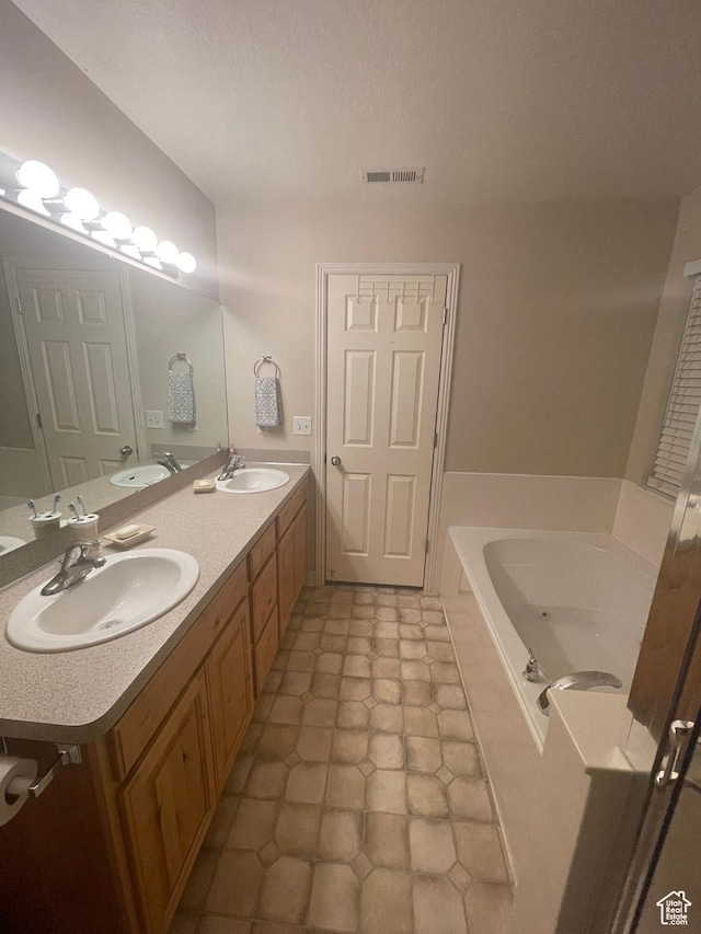 564 W 475 N, Clearfield, UT 84015 - bathroom with visible vents, a garden tub, double vanity, and a sink