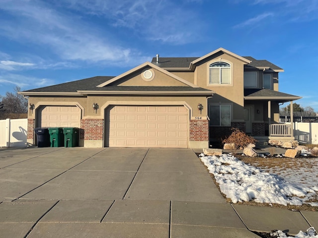 564 W 475 N, Clearfield, UT 84015 - view of front of property featuring stucco siding, driveway, brick siding, and a garage
