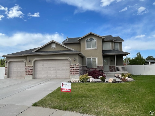 564 W 475 N, Clearfield, UT 84015 - view of front facade with a porch, a front yard, a garage, brick siding, and stucco siding