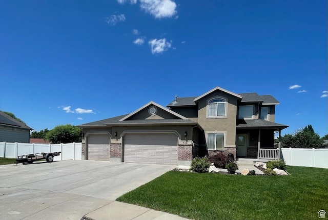 564 W 475 N, Clearfield, UT 84015 - view of front of property featuring a garage, stucco siding, driveway, brick siding, and covered porch