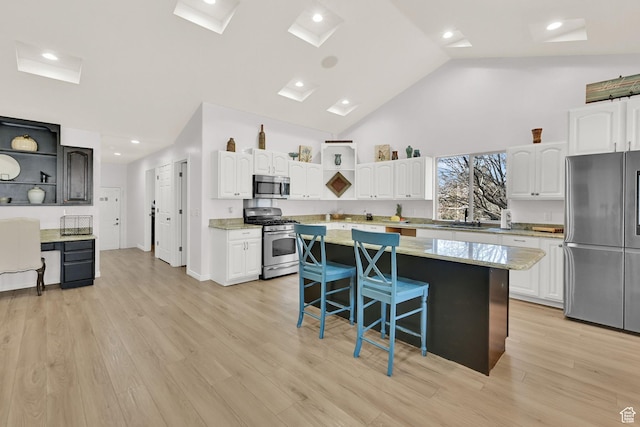 654 E 3225 N, North Ogden, UT 84414 - kitchen with appliances with stainless steel finishes, white cabinets, and a center island