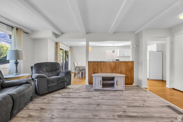 1384 Millcreek Dr Unit 6, Ogden, UT 84404 - living area with visible vents, light wood-style flooring, and beam ceiling