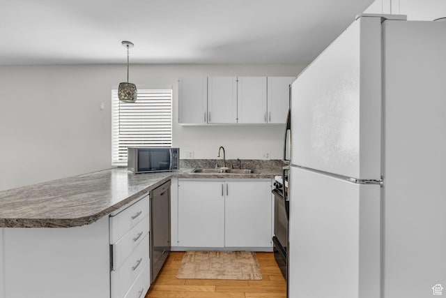 1384 Millcreek Dr Unit 6, Ogden, UT 84404 - kitchen with freestanding refrigerator, dishwasher, white cabinetry, and a sink
