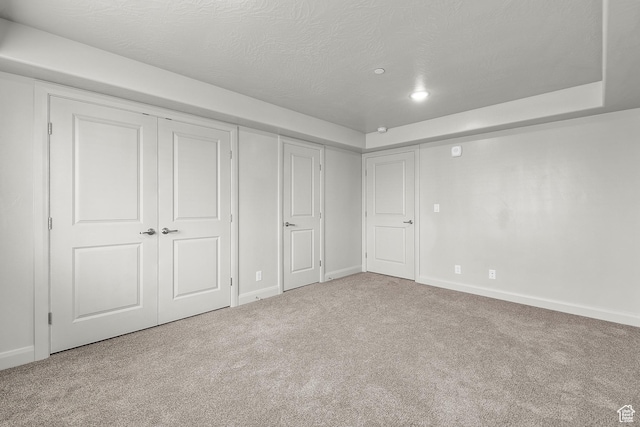 128 N Lone Rock Dr Unit 202, Hurricane, UT 84737 - unfurnished bedroom featuring a closet, carpet flooring, a textured ceiling, and baseboards