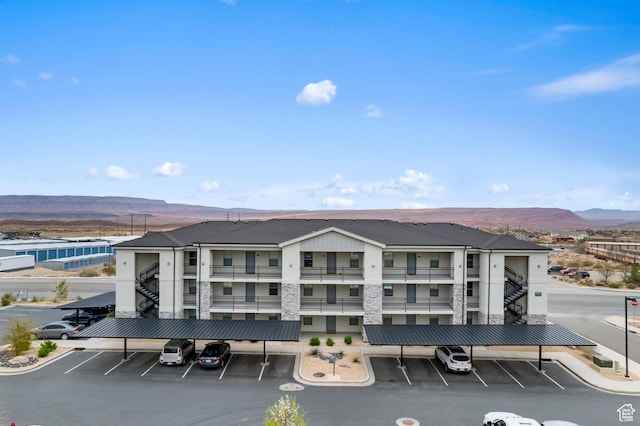 128 N Lone Rock Dr Unit 202, Hurricane, UT 84737 - view of building exterior featuring covered parking and a mountain view