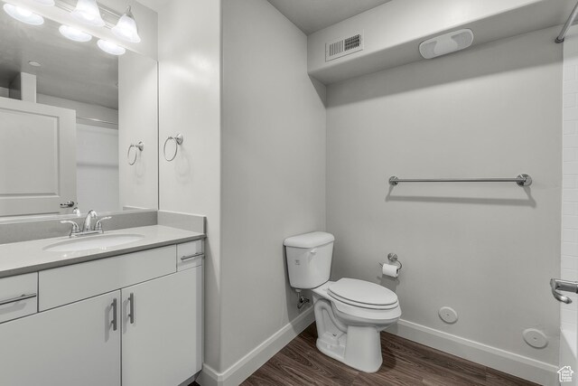 128 N Lone Rock Dr Unit 202, Hurricane, UT 84737 - full bathroom featuring visible vents, toilet, vanity, wood finished floors, and baseboards