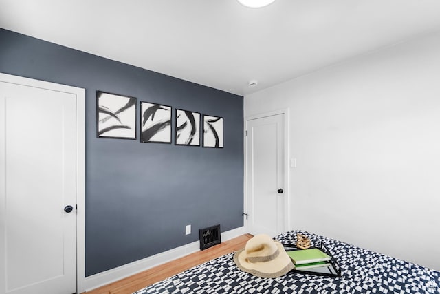 interior space featuring baseboards, visible vents, and light wood-style floors